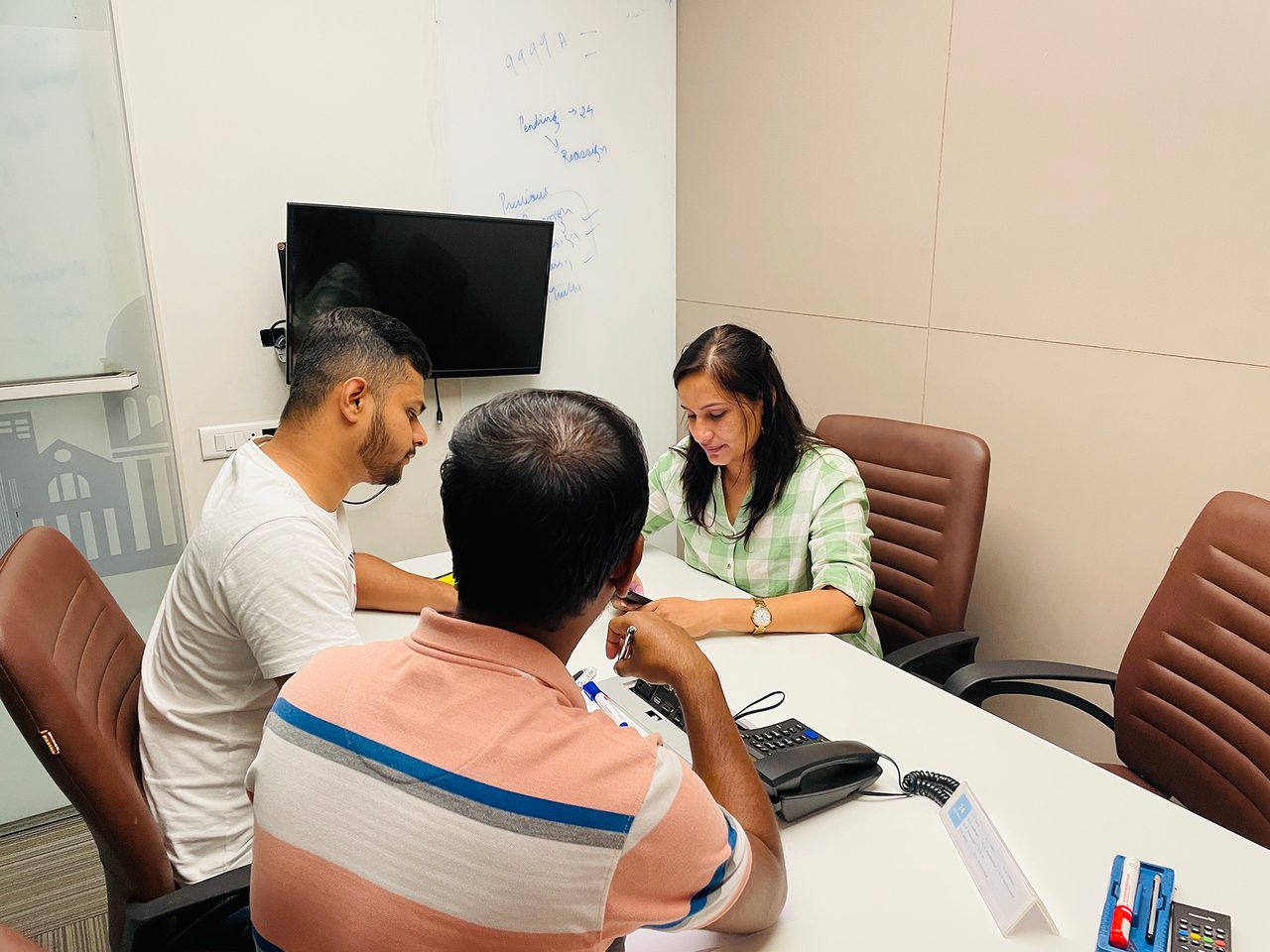 Another participant works through a task on the app while a team member observes.