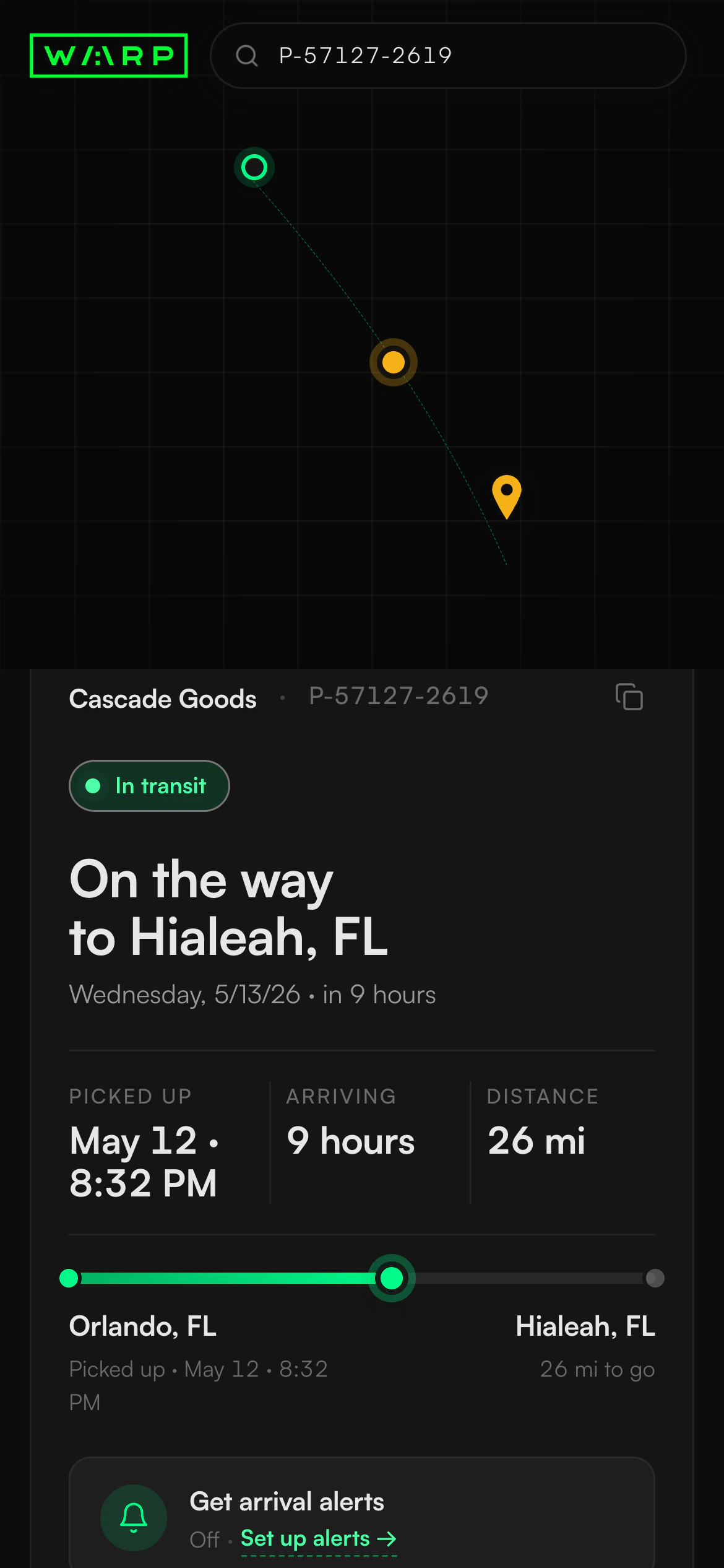 The redesigned Warp tracking page on a phone: a dark card that leads with the status 'On the way to Hialeah, FL', the estimated arrival time, a pickup-to-driver-to-dropoff journey strip, and the recent activity below, over a route map.